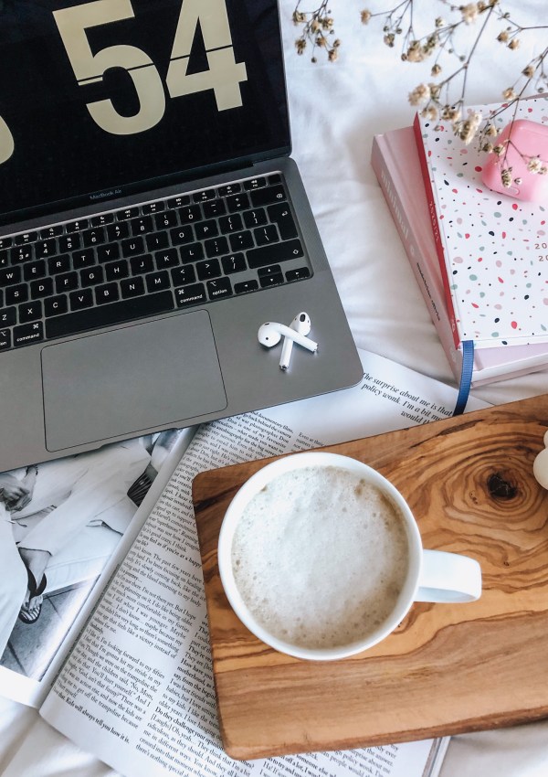 Macbook, Airpods and a cup of coffee.