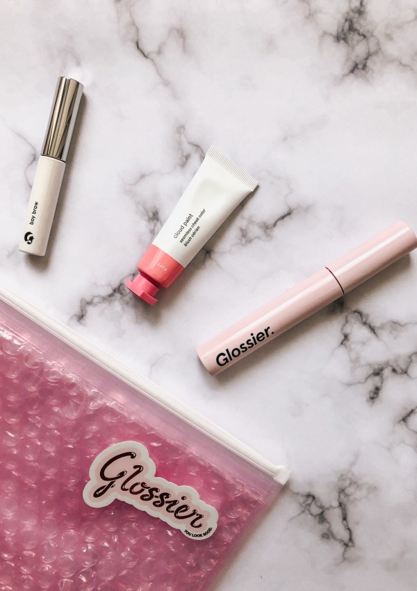 Glossier daily makeup staples including boy brow, cloud paint and lash slick.