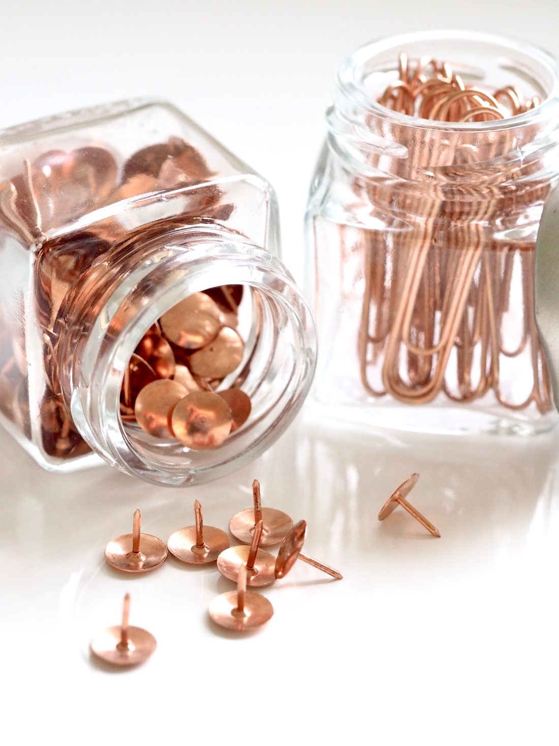 Jars of thumb tacks and paper clips.
