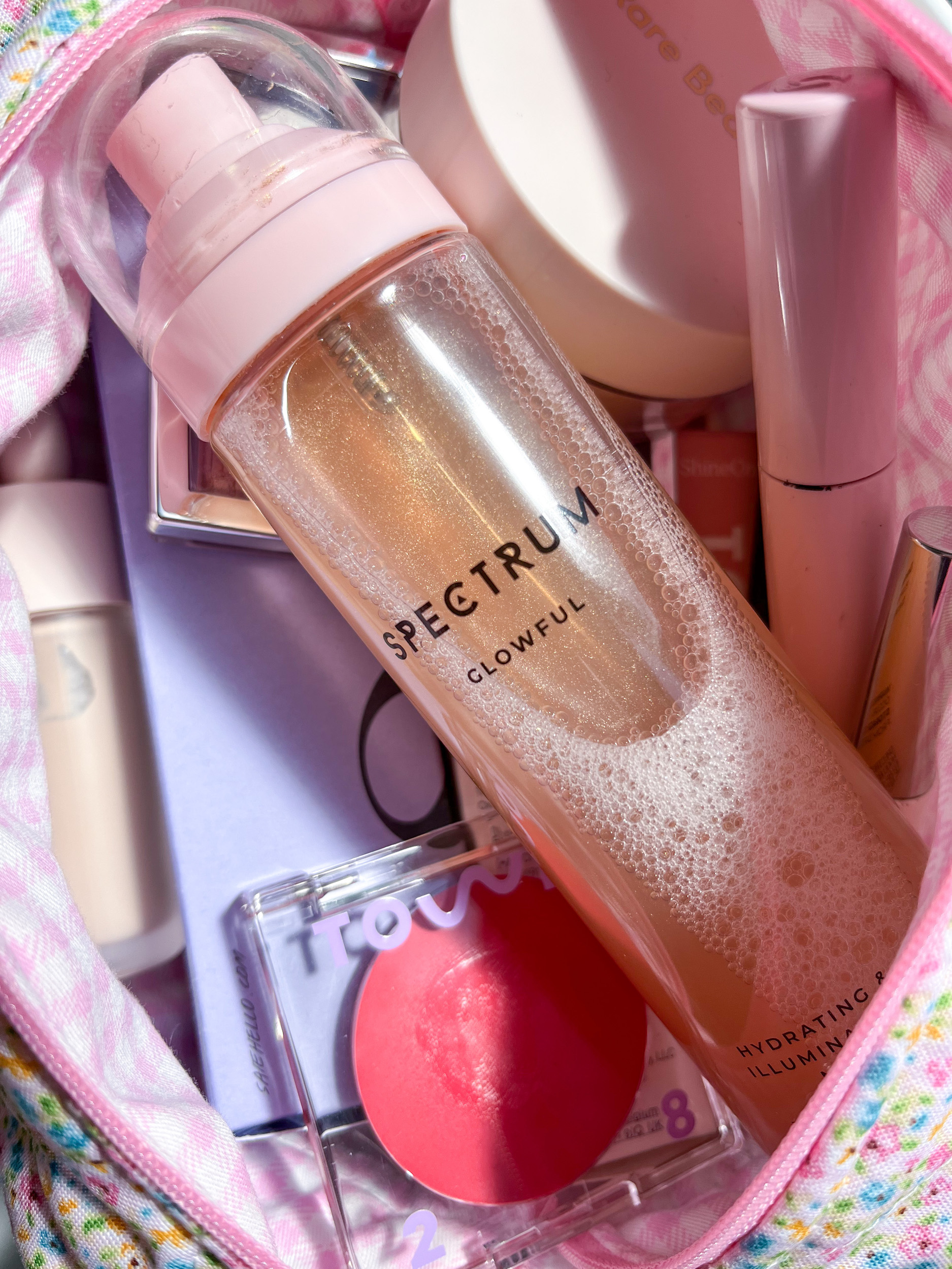 Makeup bag filled with summer makeup products